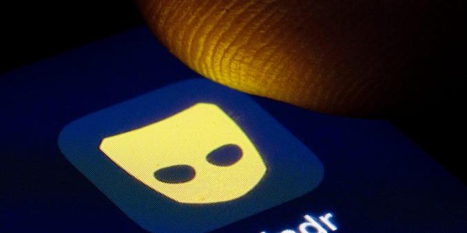 Grindr app icon about to be pressed by finger