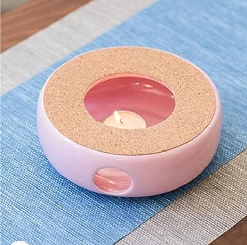 tealight in a tealight teapot pink warmer : it is a cerimic circle with a small hole to put the candle and ventilation with liege on top that form a round with a small hole to hold your teapot