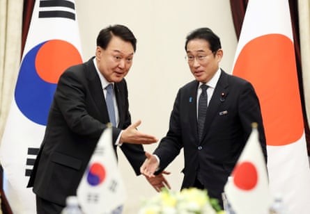 South Korean president Yoon Suk Yeol gestures to Japanese prime minister Fumio Kishida to take a seat, during their talks on the sidelines of the Nato Summit in July 2023. Photograph: YONHAP/EPA