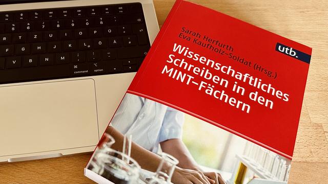 Buch neben Tastatur. utb. Herausgeberinnen: Sarah Herfurth, 
Eva Kaufholz-Soldat.
Wissenschaftliches Schreiben in den MINT-Fächern.