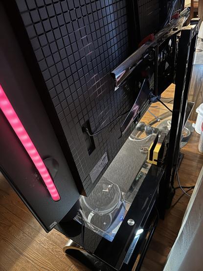 The rear of the tv.
It’s difficult to photograph as it’s dark. But all cables route through the built in cableways. I’ve wrapped the cable bundle in a simple black wrap thing that keeps things tidy. Again, a good cat deterrent from chewing.
The three cables in the floor (one is technically floating in space and nailed to the wall to keep the curtain closed) are the two Ethernet and one power strip cables.
No cables or structures jut out from the back.
