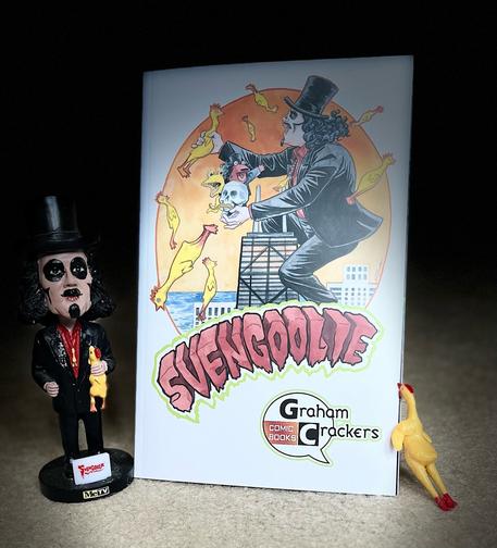 The first of three images shows a Svengoolie bobblehead next to the Graham Crackers Comic Books  exclusive cover for the FMP comic book Svengoolie: Lost in Time (2023) featuring artist Jill Thompson’s rendering of a giant Svengoolie atop the John Hancock building in Chicago, holding a rubber chicken in one hand and characters Kerwyn, Sventoonie, and Tombstone in the other