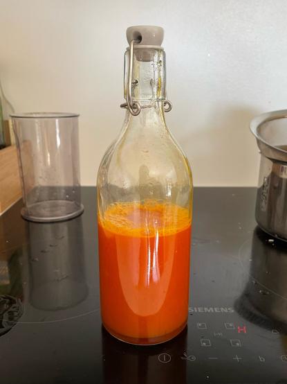 The final product: a bottle of sea buckthorn cordial with it's prominent, carrot-like orange colour.