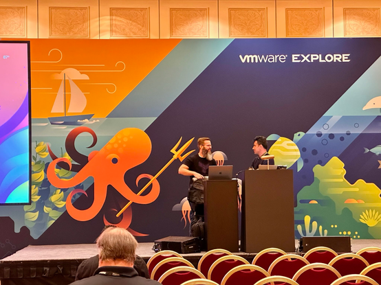 Kyle Ruddy and Kamen Nikolov on stage at VMware Explore, doing some pre-session prep