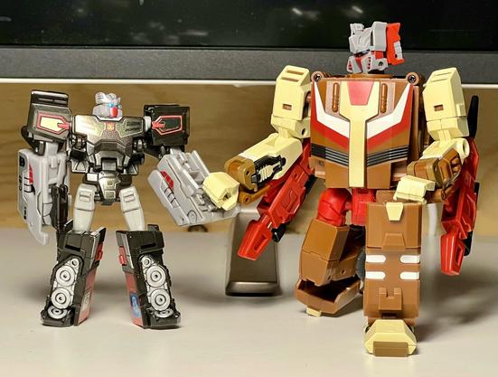 Rewind and Chromedome in bot mode holding hands :3 . Rewind is short and Chromedome is kneeling.