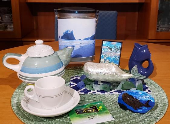 A tea tableau with whales and pineapple black tea.