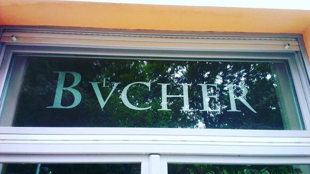 A shop sign on a window saying “Bvͤcher” (i.e. “Bücher”, German for books) in small caps