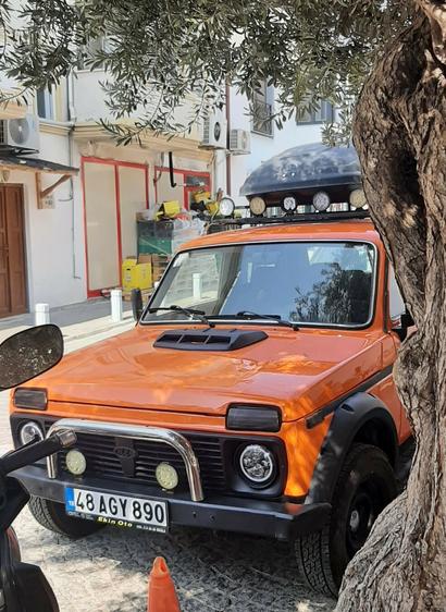 Front side view of orange Lada Niva