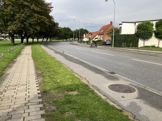 A view of a road containing distinct pedestrian, cycle, and motor vehicle lanes, all separated from each other.