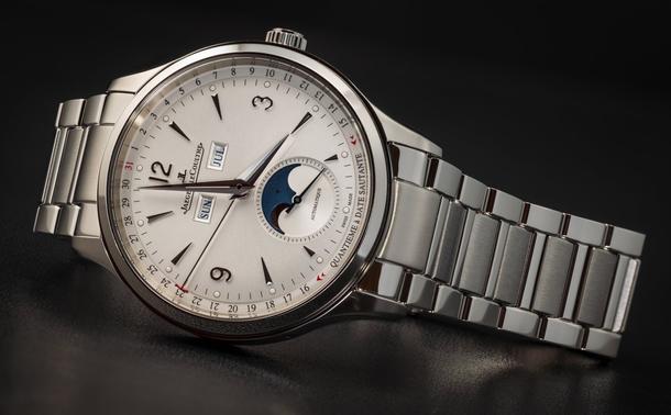 A Jaeger-LeCoultre full-calendar watch (with an off-white dial) in stainless steel on a stainless steel bracelet, lying on its side