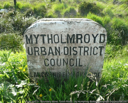 White stone amid typical moorland vegetaiton, reading "Mytholmroyd Urban District Council"

Below that it shows the bourndary between Lancashire and Yorkshire