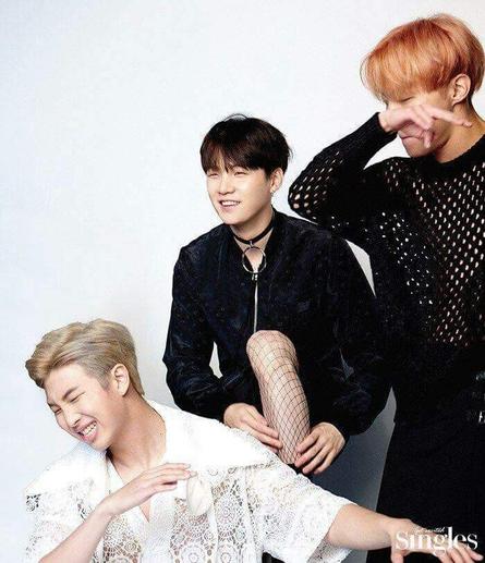 Members of the rapline posting goofily. The important thing is that Yoongi is wearing fishnets.