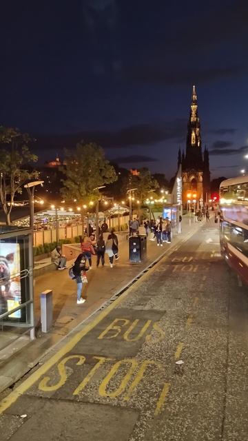 Princes Street and the Scott Monument viewed from the top deck of a bus at night