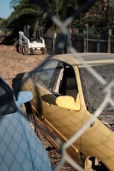 An old disfunctional car in some backyard.