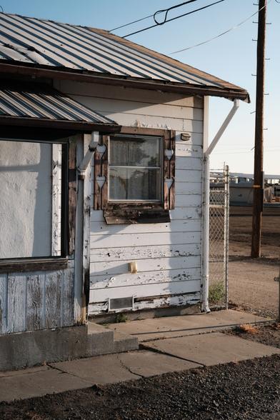 An old shed with some rusty windows in morning light.