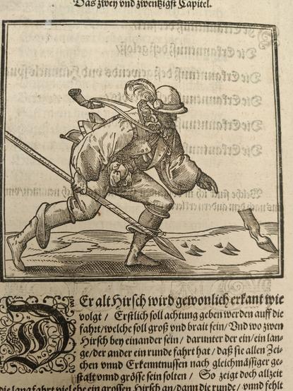 Woodcut of hunter with a spear bent over looking at deer tracks, including a truncated leg.
