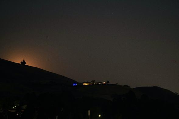 The moon's halo lights up the sky above the location where the moon is set to rise.
