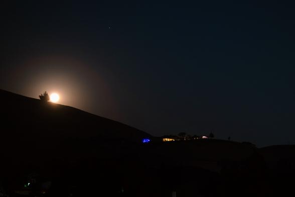 The moon has appeared! There are rings and discoloration due to smoke from fires in California.
