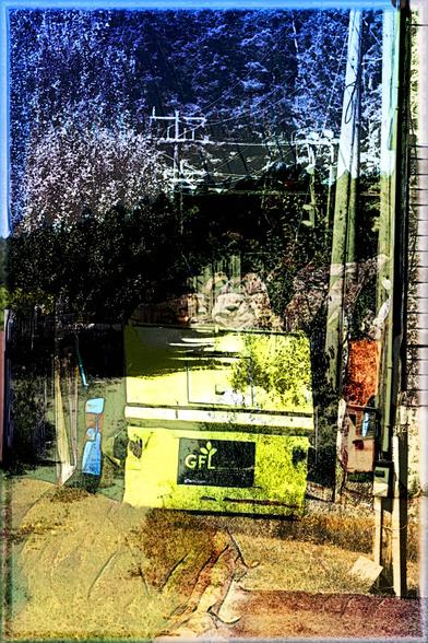 This composition is a blend of a photo of a recycling bin with a tree covered escarpment in the background, and a photo of trees and a hydro-lines with supporting poles.