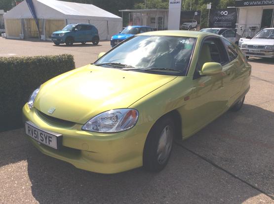 Yellow/green metallic first-generation Honda Insight, front quarter view