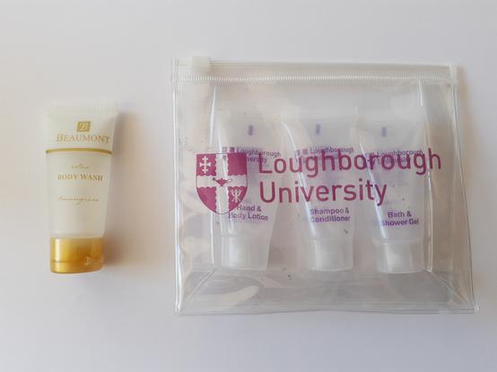 Left: a tube of "Beaumont" body wash
Right: a Loughborough University plastic bag with 3 tubes: Hand & Body Lotion, Shampoo & Conditioner, and Bath & Shower Gel