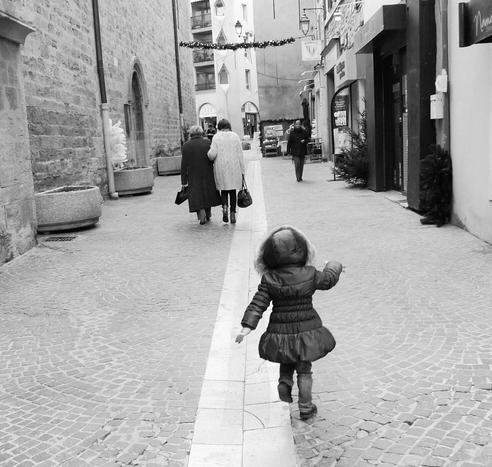 Une petite fille courant de bonheur dans une ruelle.