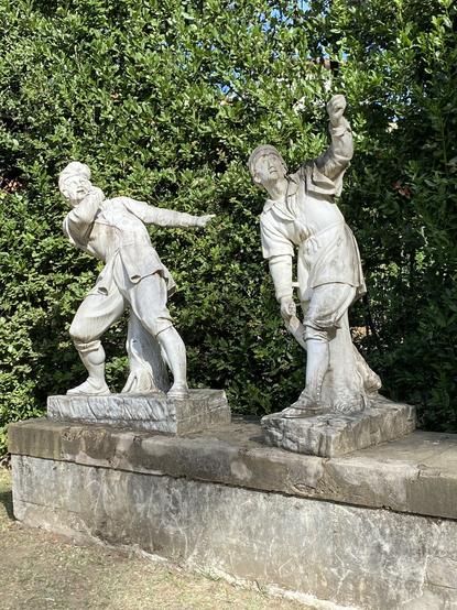 Two statues with a back movement.