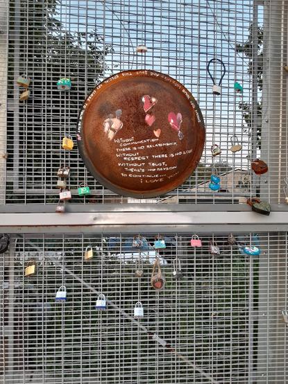 Love Locks display by the bridge. Hand painted/ decorated locks clipped to bridge fencing.