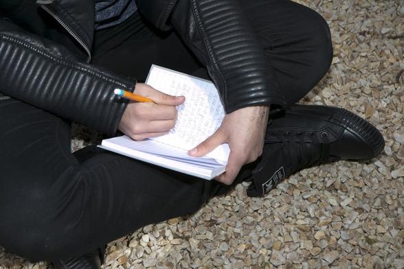 young writer's notebook in their lap