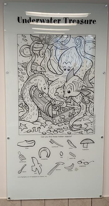 An under water ocean themed hidden object game. An octopus fish and eel are peering into an open treasure chest.