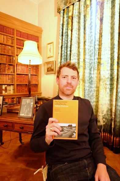 Adrian Duncan holds his book The Geometer Lobachevsky