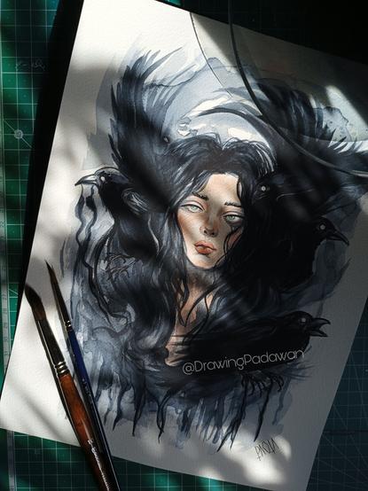 Escena de trabajo con la ilustración terminada y pinceles en un lateral.