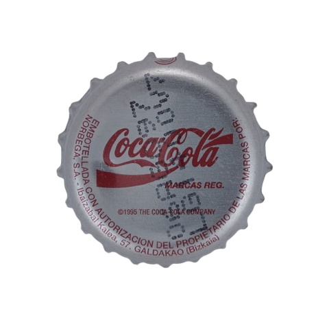 Coca-Cola bottle cap, dark red text on a silver metal cap, from the 90s.