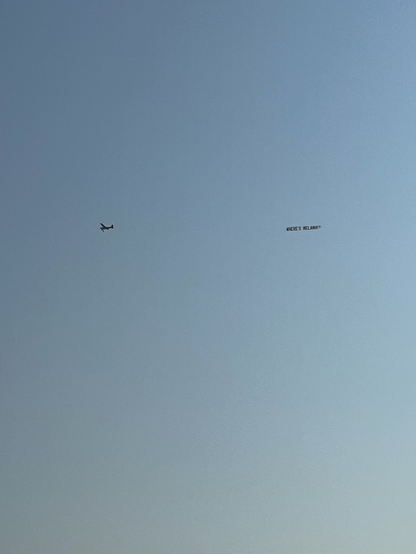 A plane flying a banner that says where’s Melania