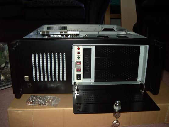 4U rackmount ATX case with the front panel open showing status LEDs, drive bays, and reset buttons.