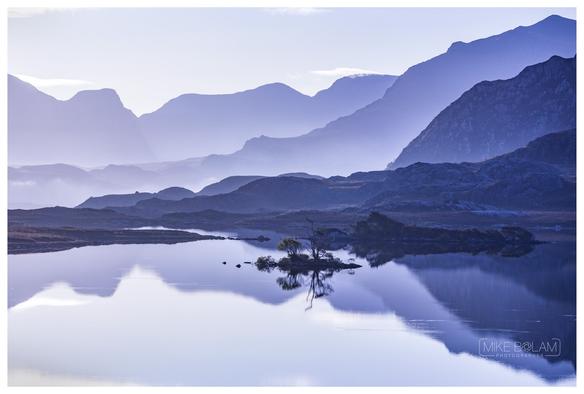 Loch Tollaidh, like a mirror reflection the mountains around Poolewe, broken only by small ripple from feeding trout.