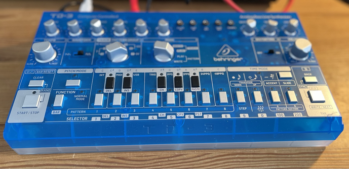 Picture of a Behringer TD-3 with blue transparent case hooked upbringings my mixer