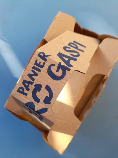 The strip with the inscription becomes the handle.