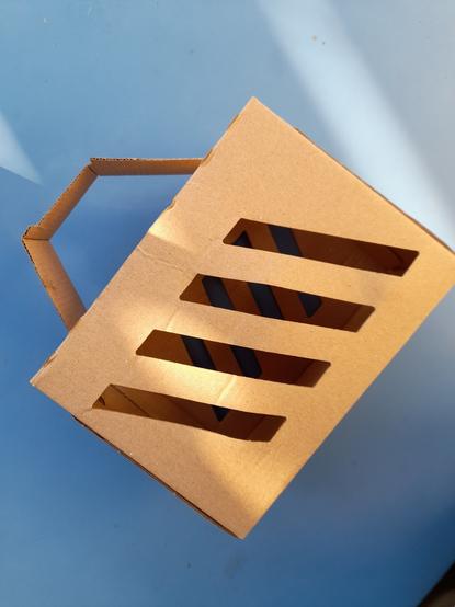Side view of the "basket". Diagonal strips of openings and the openings at the top should overflow with paper butterflies.