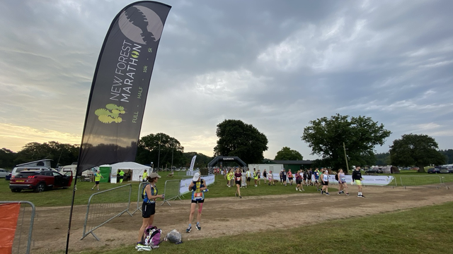 New Forest Marathon flag surrounded by runners