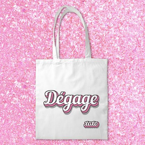 Tote bag 100% coton avec le texte blanc et rose "Dégage" imprimé, idéal pour faire passer un message quand vous êtes de mauvaise humeur ! A retrouver dans notre boutique en ligne : ernestine-etcie.fr