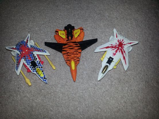 Original G2 Space Case is joined by two cheap Knock-Off representations of him and fellow CyberJet Hooligan. Hooligan's clone I have named "Ruffian". But the Space-case clone has a novel electric-spark on white deco so I have named him, somewhat boringly, Lightning.
