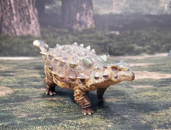 A front view of an incredibly detailed armoured dinosaur toy.