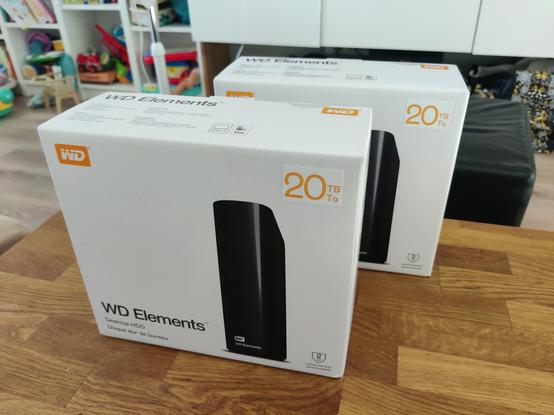 Two boxes of WD Elements 20TB external hard drives.

The boxes are resting vertically on a wooden coffee table