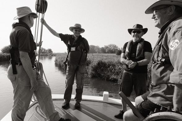 Four crew members of the wherry Albion, standing at the bow of the boat.