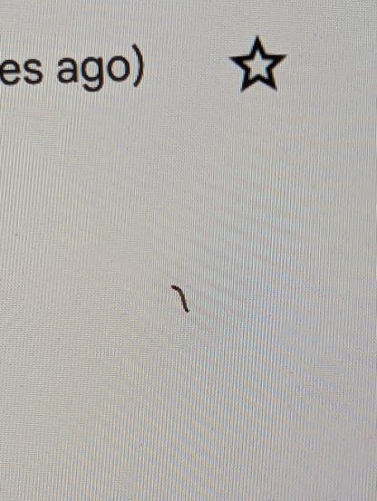 Very tiny black streak on a computer screen that looks like an out-of-shape parenthesis, with some text and any actual parenthesis - maybe 10 point? - visible near the edge of the photo.