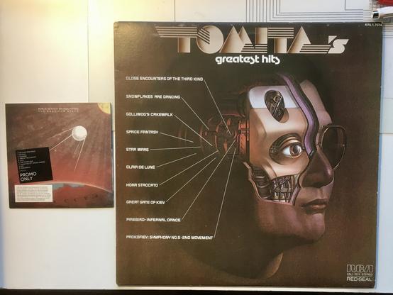 A CD cover and a 12" vinyl record cover. The CD is Public Service Broadcasting's The Race for Space, showing a reddish space background, sputnik satellite in foreground, and a reddish earth below with CCCP visible on the map of the planet. Song list and Promo Only copy text, as well as a warning about copyright and digital watermarking.

The Record Album is Tomita's Greatest Hits, showing the song list and an illustration of a blocky robot head.