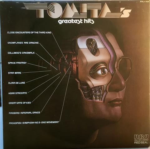 A 12" vinyl record cover. 

The Record Album is Tomita's Greatest Hits, showing the song list and an illustration of a blocky robot head.