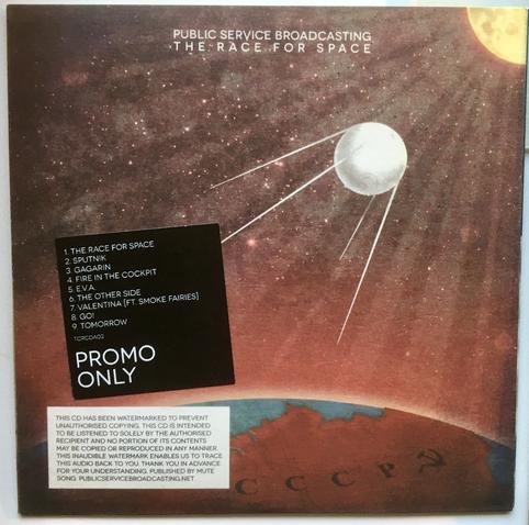 A CD cover. The CD is Public Service Broadcasting's The Race for Space, showing a reddish space background, sputnik satellite in foreground, and a reddish earth below with CCCP visible on the map of the planet. Song list and Promo Only copy text, as well as a warning about copyright and digital watermarking.