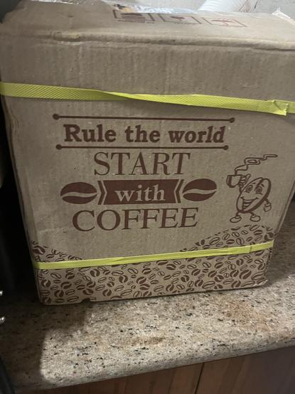 A carton that says “Rule the World, Start with Coffee”